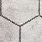 Tapis artisanal gris et argent à motif hexagonal