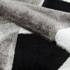 Tapis géométrique noir et blanc Pluton