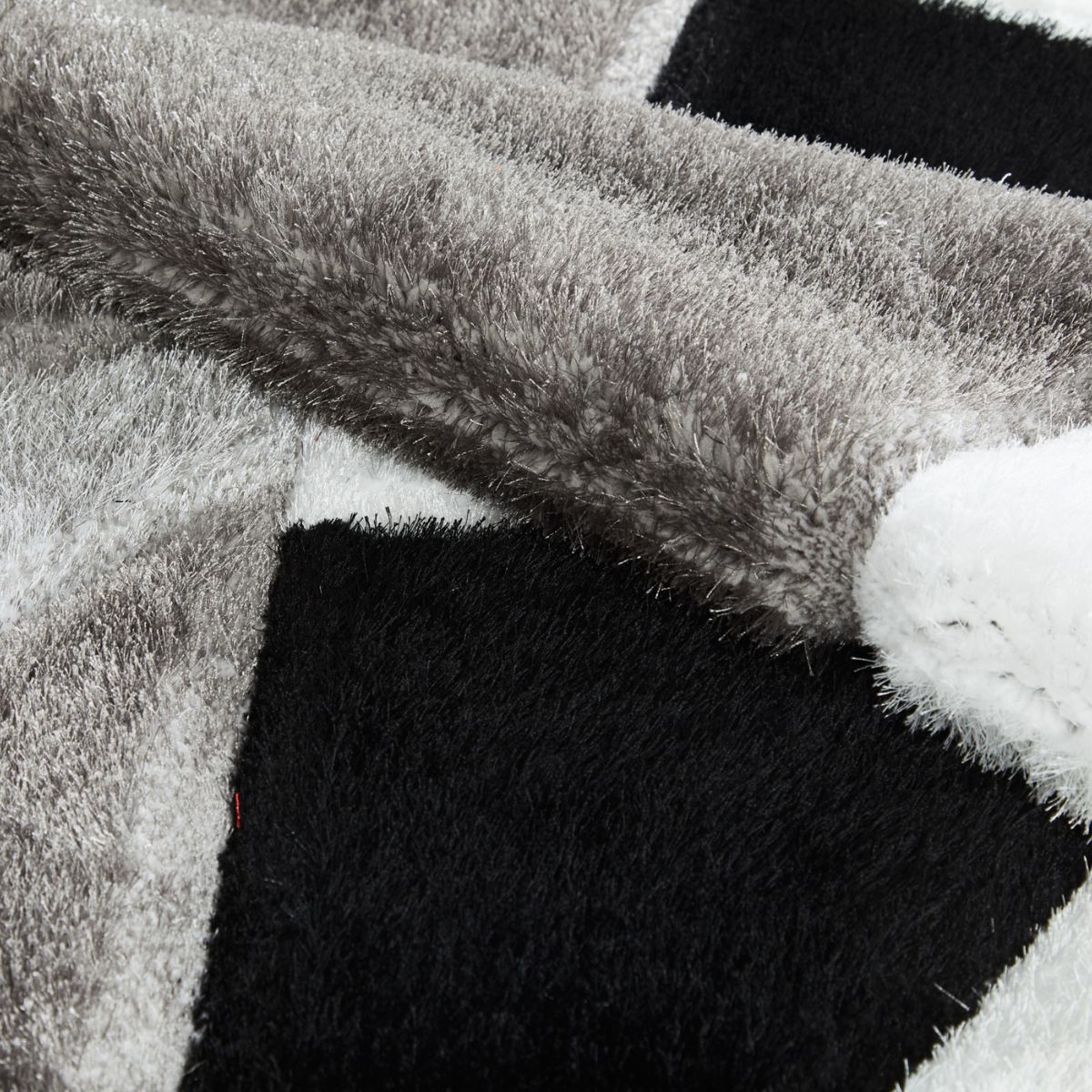 Tapis géométrique noir et blanc Pluton